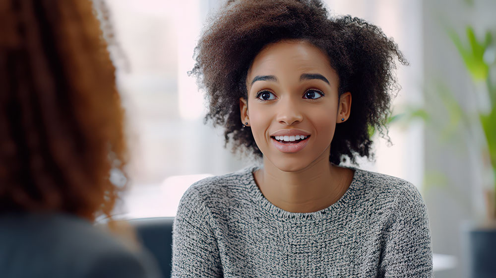 A professional offering advice to a young adult during a consultation.